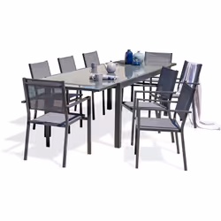 Ensemble repas de jardin composé d'une table en aluminium gris anthracite et plateau verre et de 8 fauteuils empilables en to ...