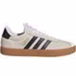 Tennis en cuir blanches et noires à semelle marron avec logo doré