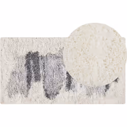 Tapis à poils longs. Tapis blanc classique avec un motif abstrait au centre. Fabriqué dans une matière synthétique robuste, i ...