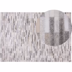 Tapis à poils courts en cuir gris. Fabriqué à la main et luxueux, ce tapis enrichira la décoration de votre maison ou de votr ...